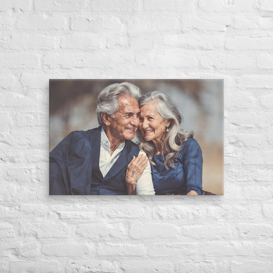 Framed photograph of an elderly couple embracing on a white brick wall.